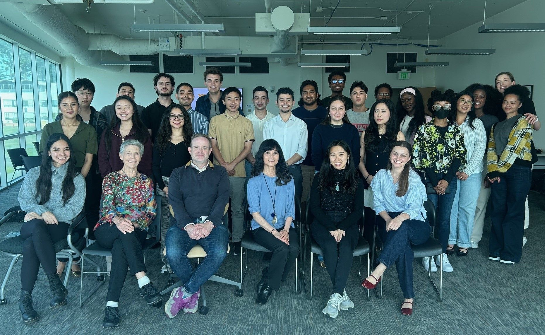 Group of SFSU students, faculty, staff, and administrators gathered in a classroom
