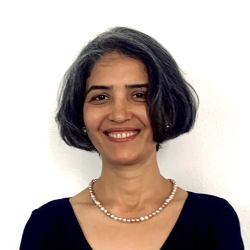 Anjali Arora headshot. Woman with short dark hair, wearing black top.