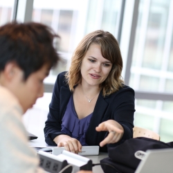 blonde female student talking with dark-haired male student